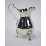 A silver baluster cream jug in the Georgian manner, with scroll handle and pad feet,