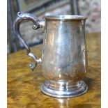A silver baluster mug with scroll handle and moulded foot-rim, Mappin & Webb, London 1939, 7.