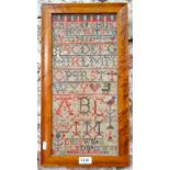 A George III alphabet sampler, Sibella Manson 1811, 43 x 20 cm, in glazed maple frame,