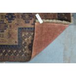 A Persian Hakhi Balouch, geometric design on light brown ground with contrasting border,