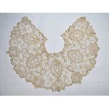 A late 19th century lace collar with floral sprays and roundels, 163 cm (outside edge) x 29 cm wide,