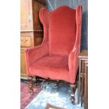 A late 19th/early 20th century wing armchair in the George II style,