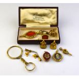 A collection of interesting mostly gilt metal items including seals, watch keys, lockets,