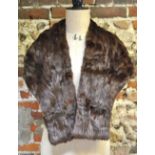 A fox fur cape with head and feet detail,