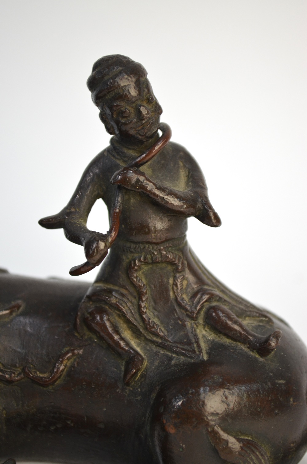 A Chinese bronze figure of a scholar seated on a recumbent buffalo, possibly a mirror stand, - Image 2 of 6