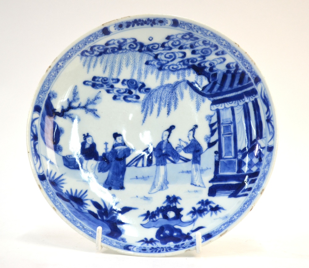 A Chinese blue and white saucer dish, decorated with a Scholar and two ladies in a narrative scene,