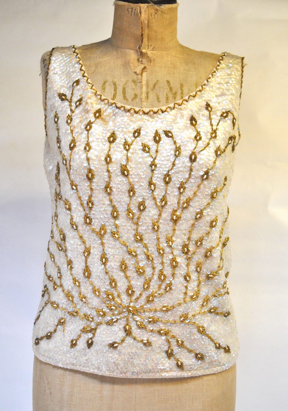 A 1950s hand-beaded and sequinned evening top lined with ivory silk, 47 cm across chest,