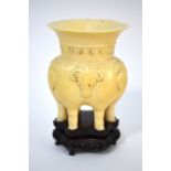 A Chinese ivory tsun, or other vessel, with three zoomorphic heads and six legs; 9cm high and 6.