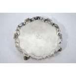 A George II silver salver with shaped and moulded rim, engraved with lion crest,