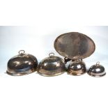 A graduated set of four Maple & Co electroplated oval meat dome covers with beaded loop handles and