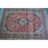 A Persian Hamadan carpet, the red ground with centre floral medallion,
