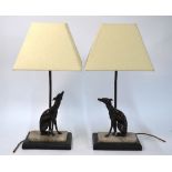 A companion pair of Art Deco table lamps with brown bronze seated dogs on grey marble bases to