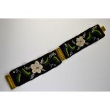 A pair of Victorian beaded bracelets on black velvet bands, with flower and leaf motifs,