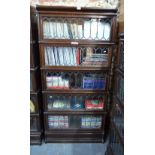 An oak five section Globe Wernicke bookcase with lead glazed doors, raised on a deep plinth base,