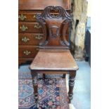 A Victorian mahogany hall chair with moulded and shaped back,