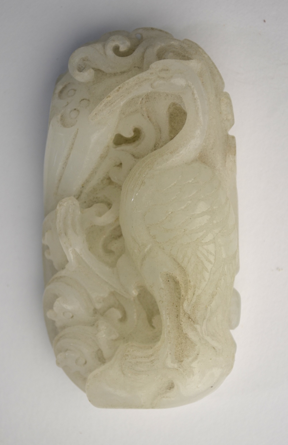 A Chinese green jade of whitish hue, carved as a Cormorant,