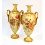 A pair of Royal Worcester blush ground twin handle vases with floral decoration, puce marks,