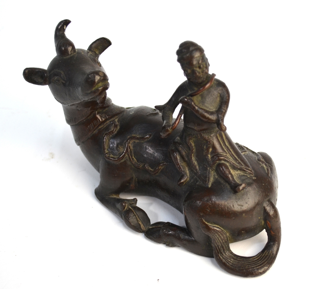 A Chinese bronze figure of a scholar seated on a recumbent buffalo, possibly a mirror stand, - Image 4 of 6