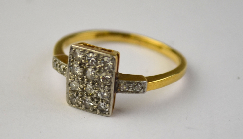 An Art Deco diamond set plaque ring set with twelve eight-cut diamonds plus two on each shoulder,