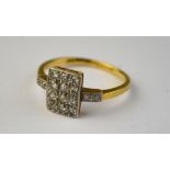 An Art Deco diamond set plaque ring set with twelve eight-cut diamonds plus two on each shoulder,
