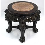 An antique Chinese veined marble inset carved hardwood stand of cylindrical form,