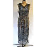 A 1920s black net flapper dress embellished with jet beads, gold-coloured beads and blue sequins,