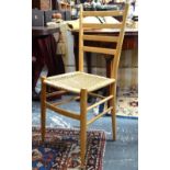 A set of four beech framed ladder back woven rope seat side chairs,
