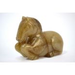 A mottled green, Chinese jade figure of a recumbent horse, 7cm long,