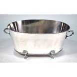A large oval electroplated champagne bath with beaded rims and twin handles,
