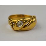 An 18ct yellow gold double headed snake ring, one set with rose diamond,