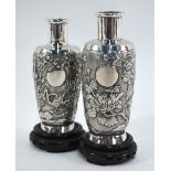 An associated pair of Chinese white metal vases;