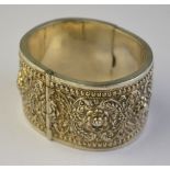 An ornate hinged cuff style bangle