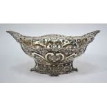 A Victorian oval fruit bowl, richly embossed and chased with roses and scrolls,