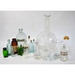An interesting selection of glass laboratory equipment, including globular flasks, measuring cones,