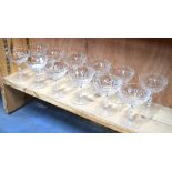 A set of one dozen champagne bowls with facetted knopped stems, 11.