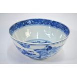 A Chinese blue and white bowl, decorated on the exterior with three figures in a lotus pond,