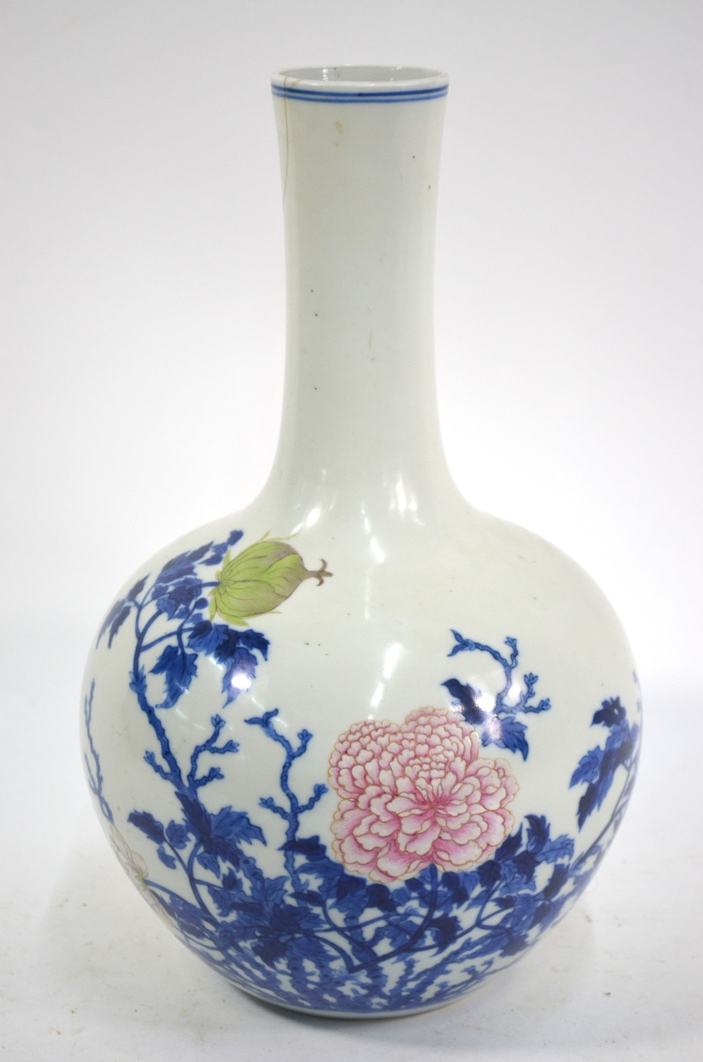 A Chinese underglaze blue and famille rose decorated vase with cylindrical neck and oviform body;