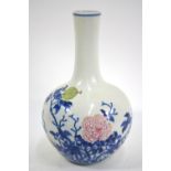 A Chinese underglaze blue and famille rose decorated vase with cylindrical neck and oviform body;