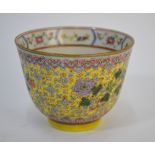 A small yellow ground Chinese cup, decorated in famille rose enamels with floral designs; 8.