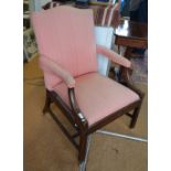 A George III mahogany framed Gainsborough style elbow chair with upholstered arched back and shaped