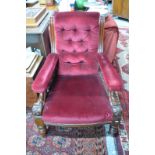 An open armchair with deep button red velveteen cover,