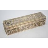 A Chinese white metal box and cover of rectangular form, decorated with floral designs,