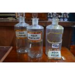 Three cylindrical glass drug jars and stoppers, for 'Aqua Menth: Pip:',