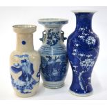 Three Chinese underglaze blue decorated vases: one of rouleau form decorated with a Scholar,