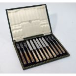 A cased set of six each Art Deco style dessert knives and forks with beaded silver handles,
