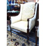 An Edwardian Sheraton Revival inlaid walnut framed and upholstered wingback armchair