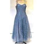 A 1950s dusky blue lace evening dress with blue silk and shell-pink tulle lining,