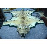 A tiger skin rug with fully modelled snarling head, felt and linen backed,