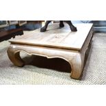 An Asian limed hardwood low centre table raised on shaped legs,