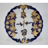 A Meissen plate moulded with grapes and vine, blue ground and with decorative gilding,